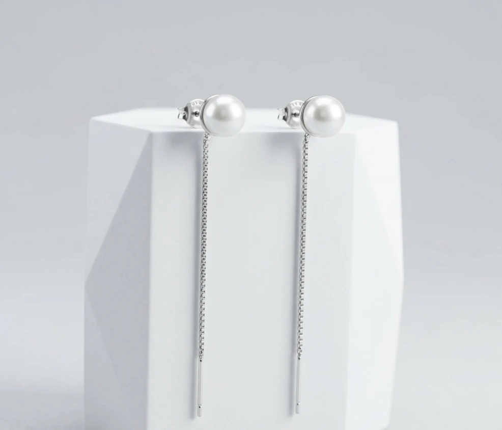 white pearl stud with a sleek hanging chain silver earrings