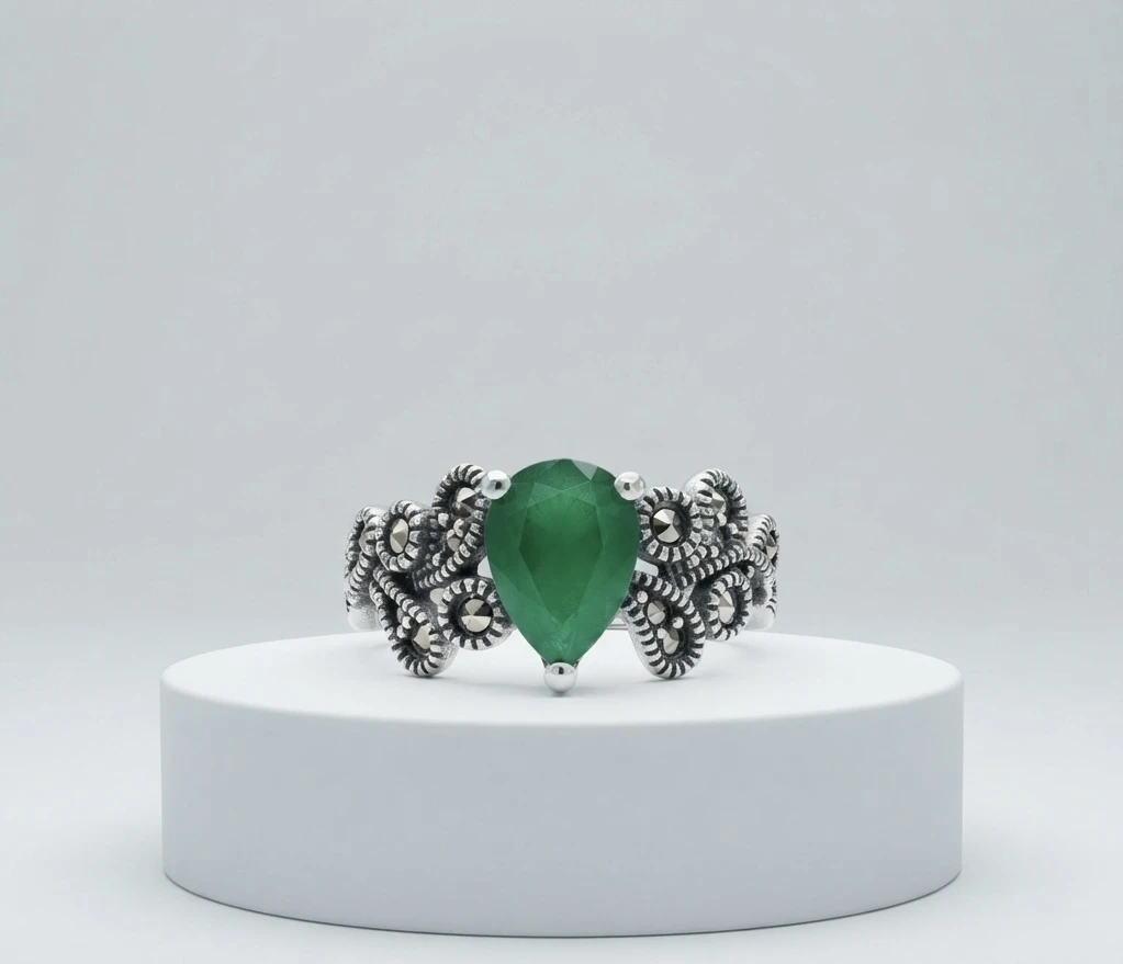 bold pear-shaped green gemstone surrounded by intricate vintage marcasite and filigree work silver ring